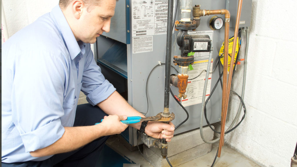 Air Specialties professional repairing a furnace in New Haven County, CT