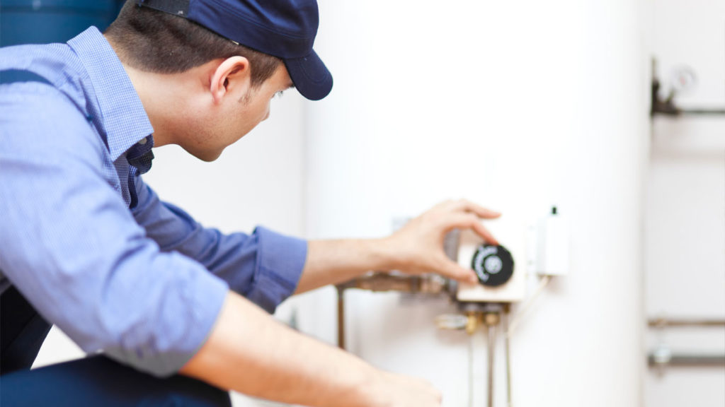 Air Specialties employee checking a replacement boiler after installation in New Haven County, CT