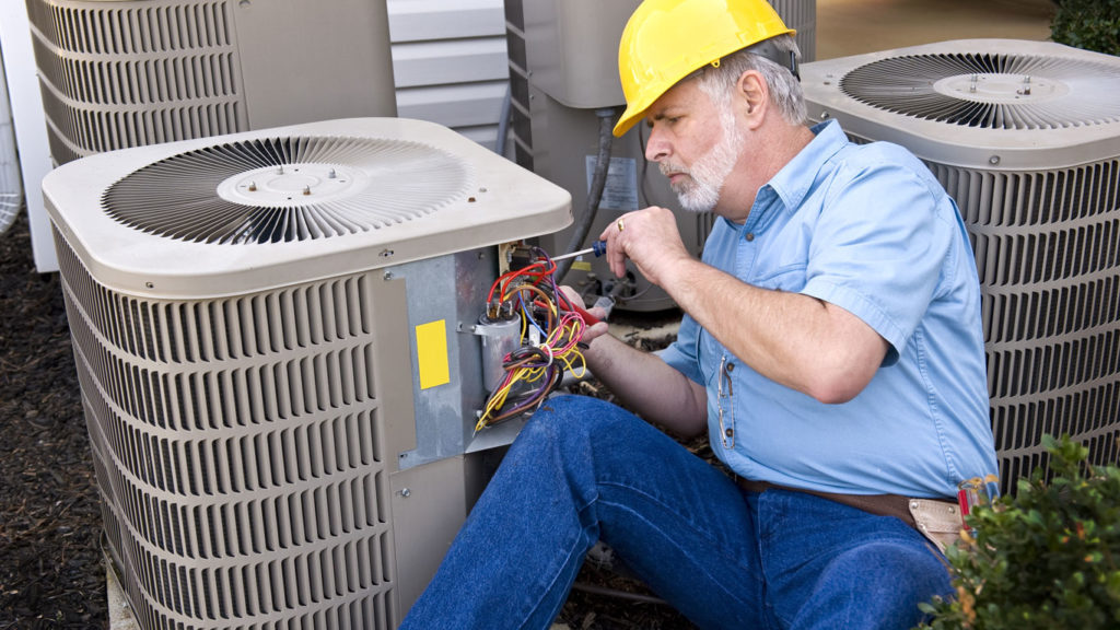 Air Specialties employee repairing an air conditioning unit in New Haven County, CT