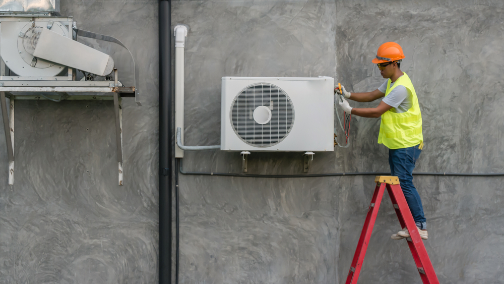 Air Specialties employee working on a commercial heating and ac system in New Haven County, CT