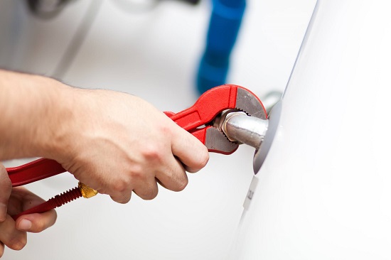 Air Specialties employee repairing a water heater in New Haven County, CT