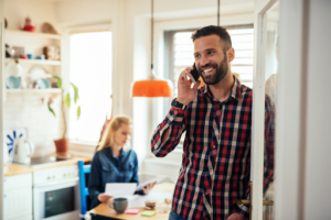 A man calling an HVAC technician for AC maintenance in West Haven, CT.