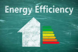 Energy efficiency written on chalkboard with a house drawn under it.
